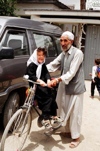 Hadisa with her father outside the Children in Crisis office in Kabul, Afghanistan after her second operation.